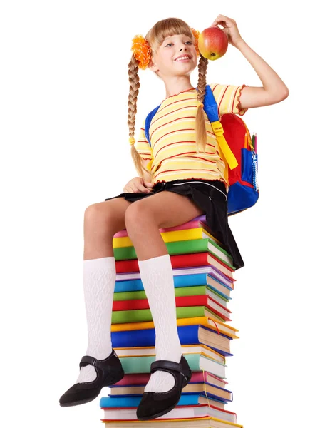 Écolière assise sur un tas de livres . — Photo