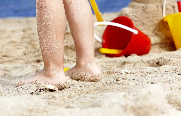 Child leg in sand. Royalty Free Stock Images