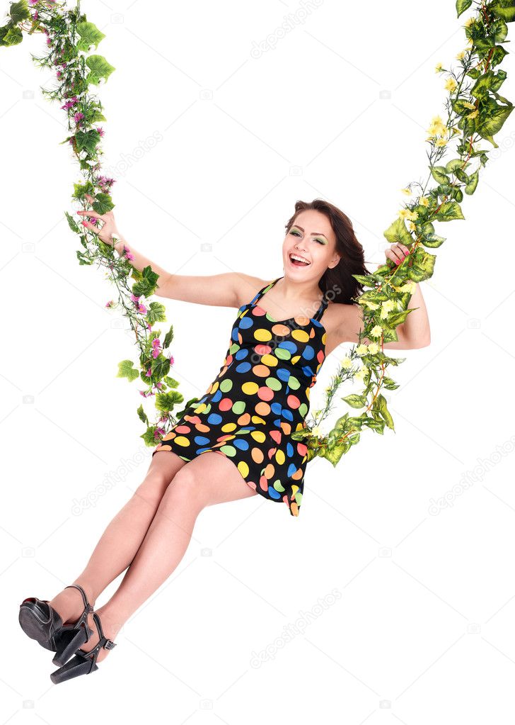 Girl swinging on flower swing.