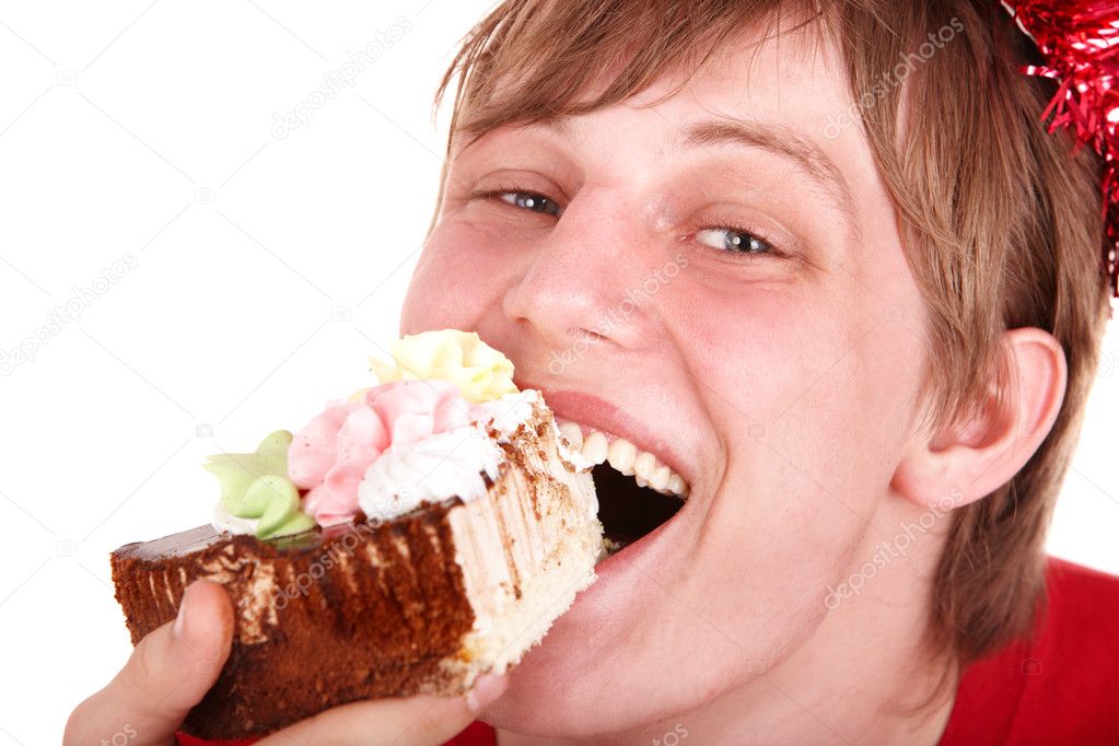 Face of man eating cake.