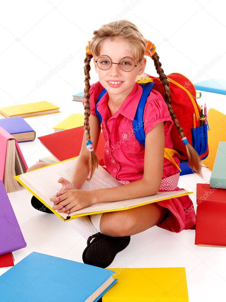 Happy sitting schoolgirl in eyeglasses with pile of books.