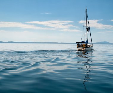 White yacht sailing on calm sea clipart
