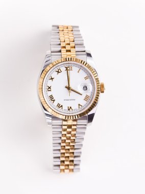 Expensive gold bevelled watch with white face and gold hands and numerals against white background clipart