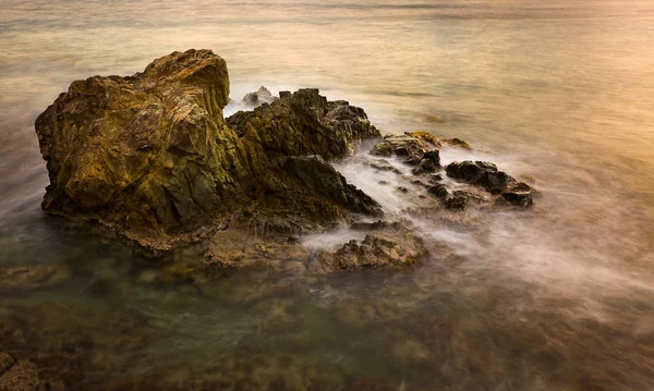 Long exposure sunset on sea rocks — Stock Photo, Image