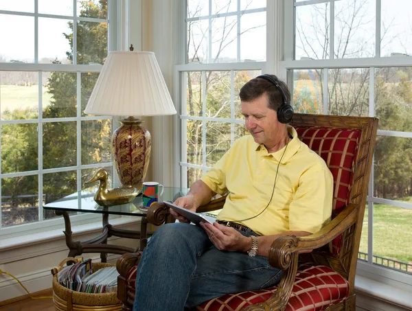 stock image Boomer reading on tablet computer