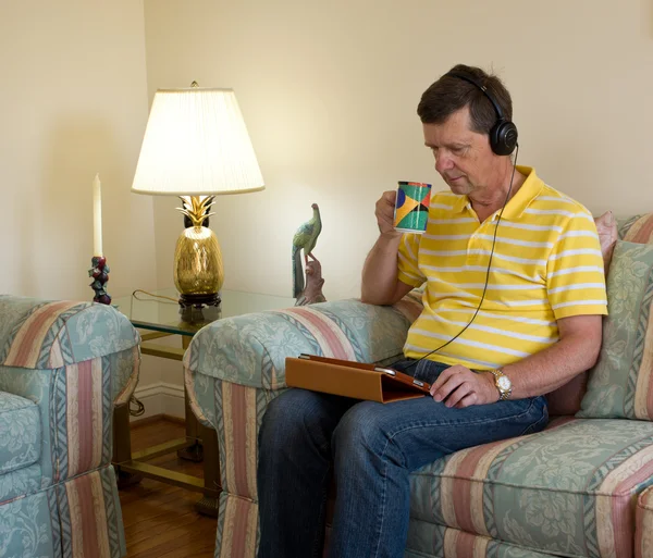 Boomer reading on tablet computer — Stock Photo, Image