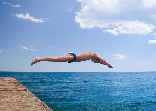 Swimmer jumping to sea water. Royalty Free Stock Photos