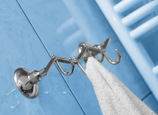 stock image The towel hangs on a hanger in a bathroom