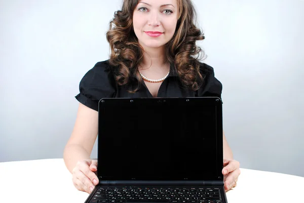 Mujer de negocios mostrando portátil en blanco — Foto de Stock