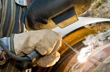 Close-up welder at work clipart