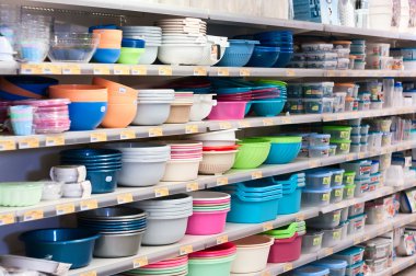 Plastic dishes on shop`s shelves clipart