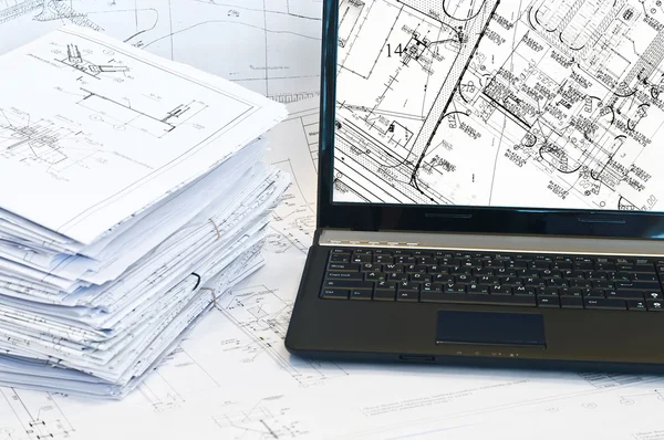 Laptop and stack of project drawings. — Stock Photo, Image