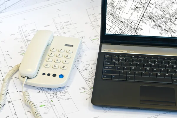 Laptop, phone on project drawings — Stock Photo, Image