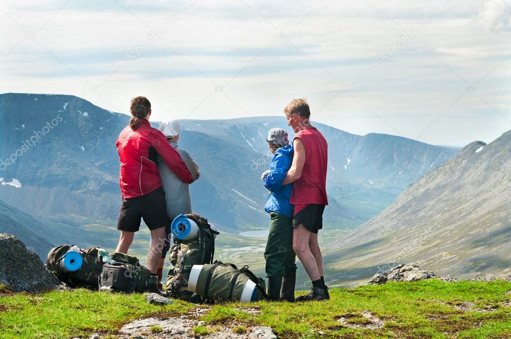 Group of travelers in mountains with knapsacks