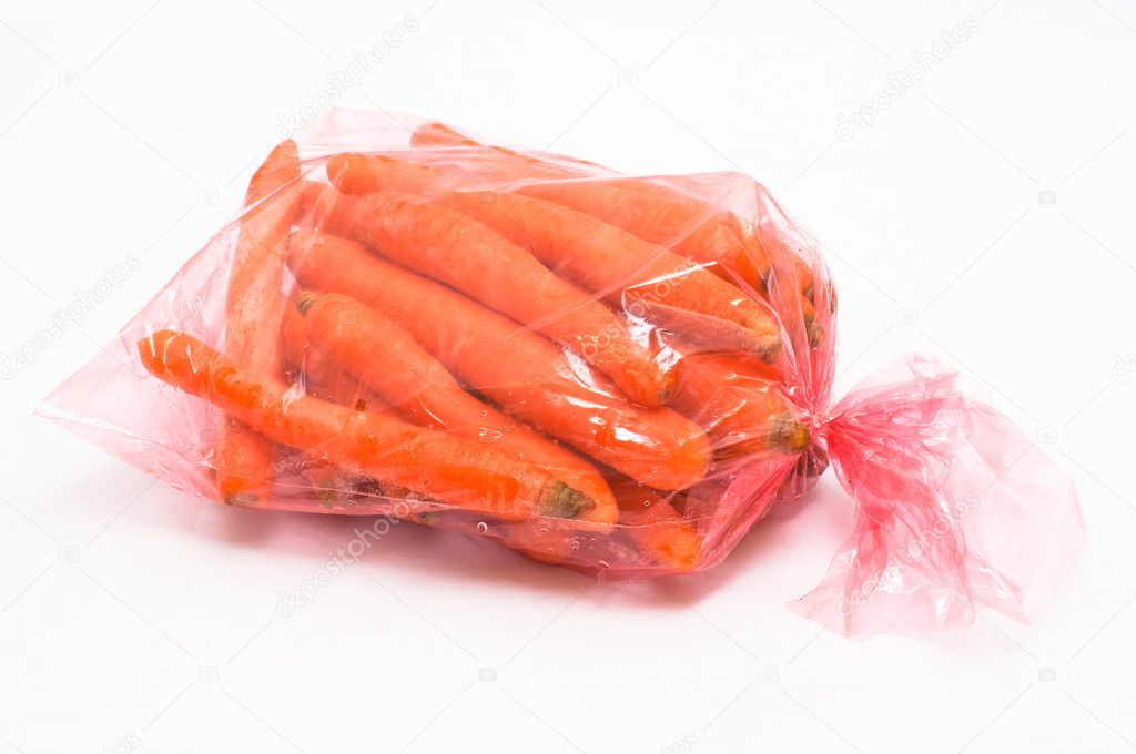Carrot in plastic bag on white background