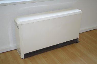 Heating convector in room on wooden floor clipart