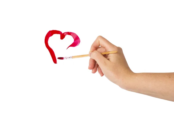 Hand with brush drawing shape of heart — Stock Photo, Image