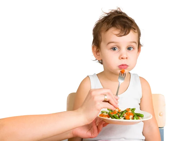 Little boy tasting vegetable salad — Stock Photo, Image