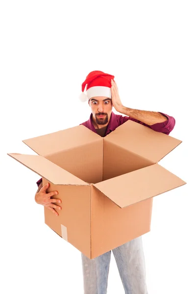 Jovem com chapéu de Natal e caixa vazia — Fotografia de Stock