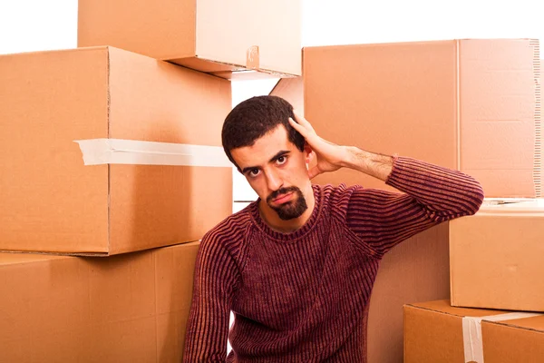 Hombre joven estresado en movimiento inundado de cajas — Foto de Stock