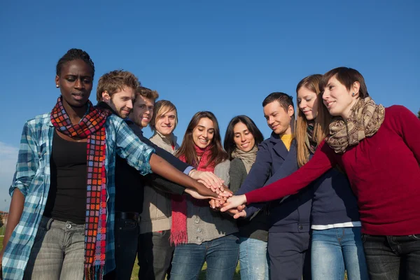 Happy College Students with Hands on Stack — Stock Photo, Image