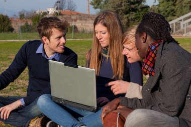 College Students with Computer at Park clipart