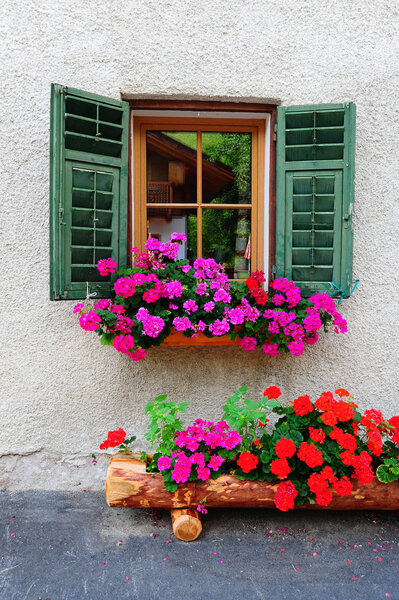 Typical Italian Window With Open Wooden Shutters, Decorated With Fresh Flowers