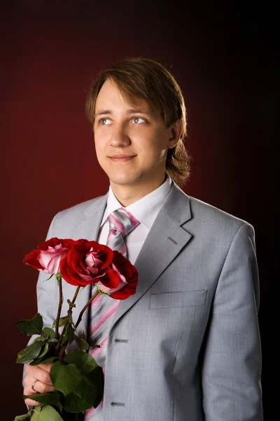 Hombre con flores —  Fotos de Stock