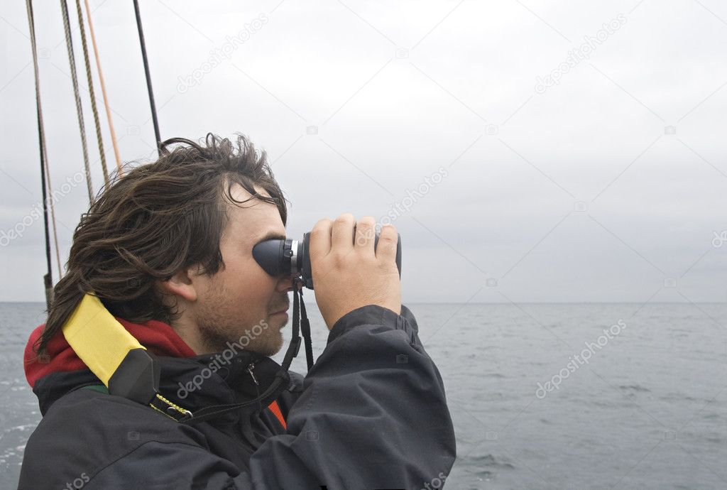 Sailor looking in binoculars