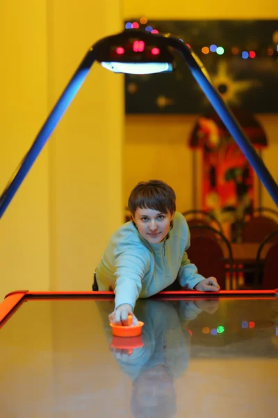 Woman is playing by air hockey — Stock Photo, Image