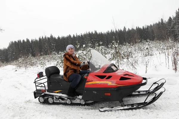 Woman on red snowmobile — Stock Photo, Image