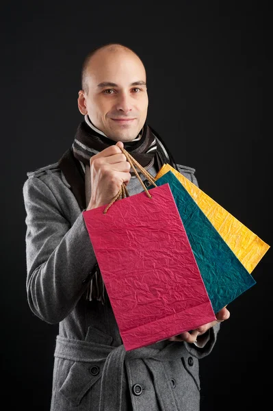 Young men with paper presents bags — Stock Photo, Image