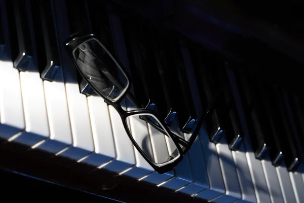 Óculos no piano — Fotografia de Stock