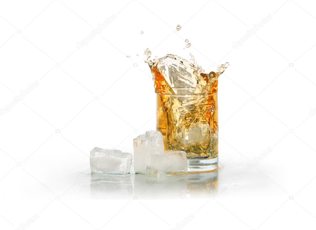 Glass of splashing whiskey near ice cubes isolated on white with clipping path