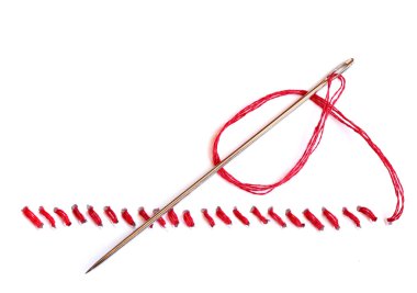 Needle with red thread and seam on white background