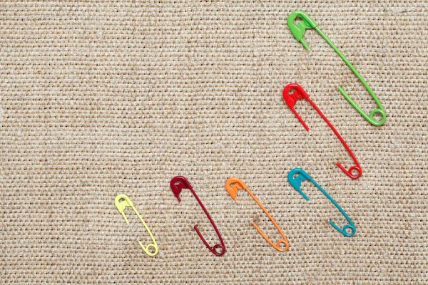 Safety Pins On Canvas — Stock Photo, Image