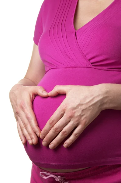 白い背景の上胃に手をハート形で妊娠中の女性のプロファイル — ストック写真