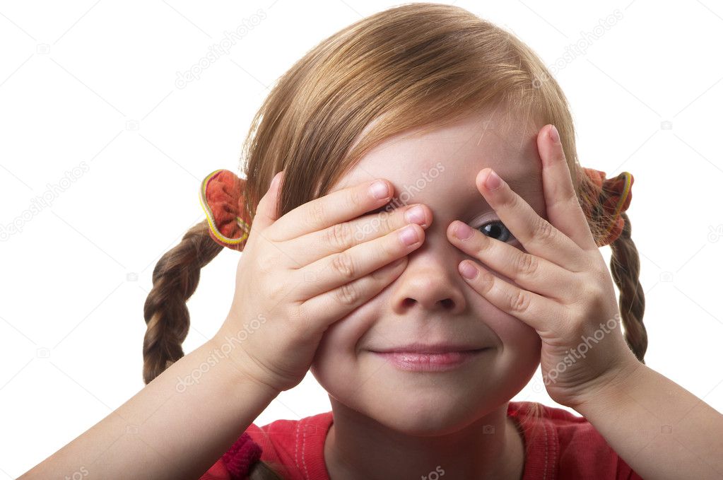 Little girl peeping through hand with one eye isolated over white background