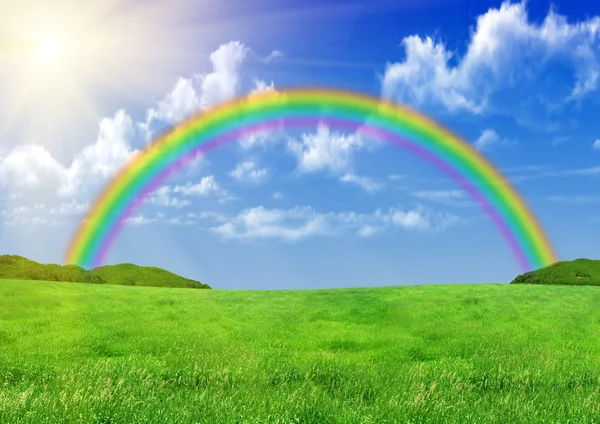 Rainbow over a green glade — Stock Photo, Image