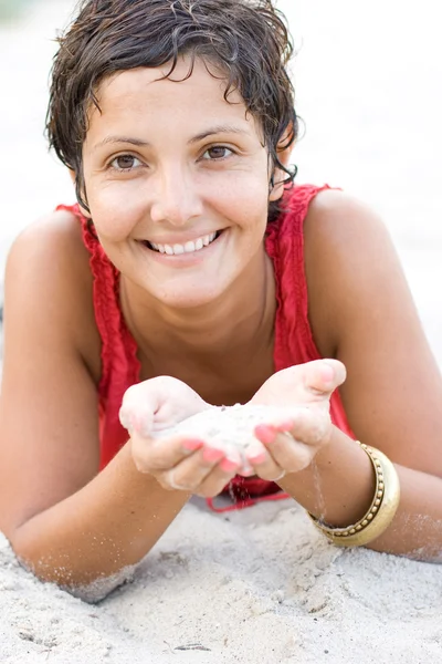 Woman in red lying on a sand — Stock Photo, Image