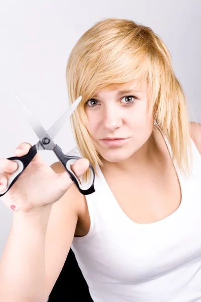 Attractive young woman with scissors — Stock Photo, Image