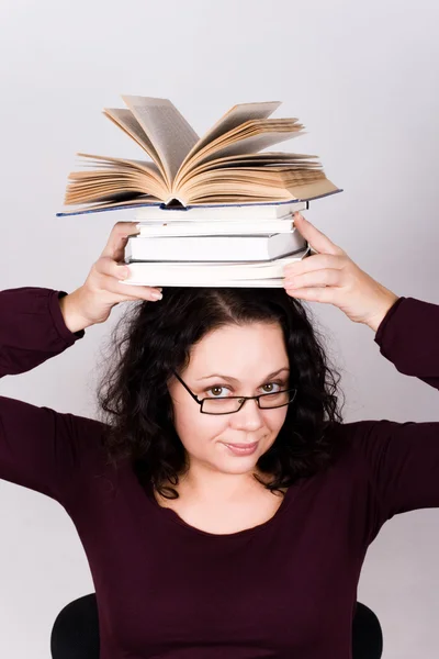 Attractive woman with stack of books — Stock Photo, Image
