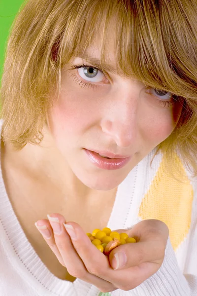 Woman with heap of yellow pills — Stock Photo, Image