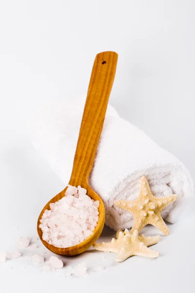 Sea salt on wooden spoon, towel and starfish — Stock Photo, Image