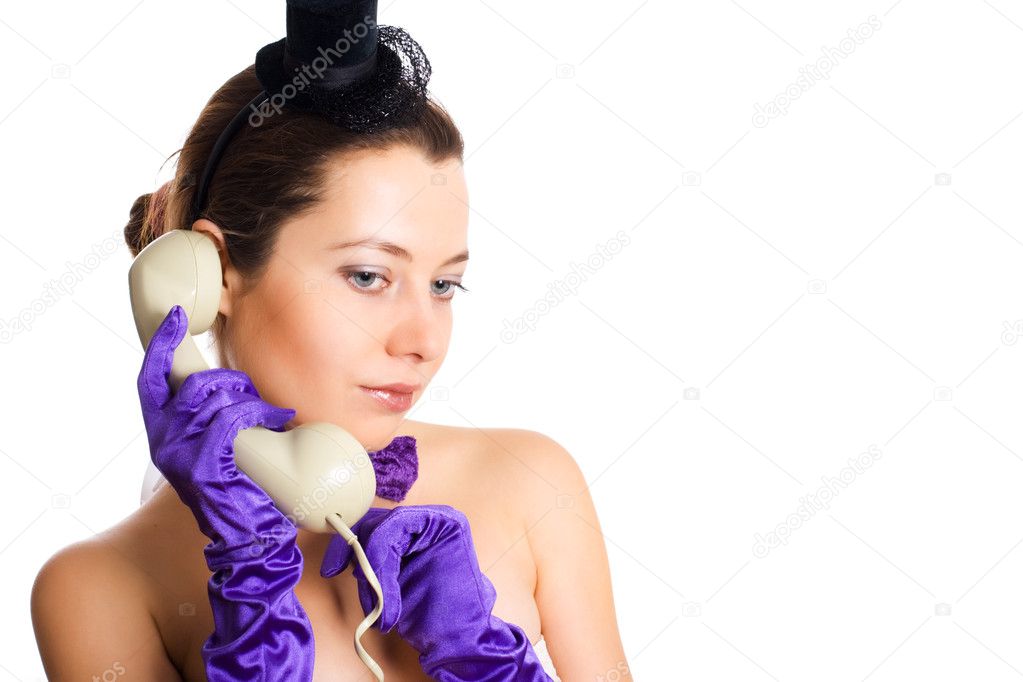 Woman in corset and little hat talking on the phone