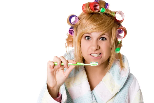 Funny housewife with curlers and toothbrush — Stock Photo, Image