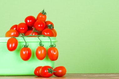 Container with fresh tomatoes clipart