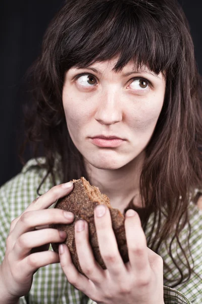 Beggar woman with a piece of bread — Stock Photo, Image