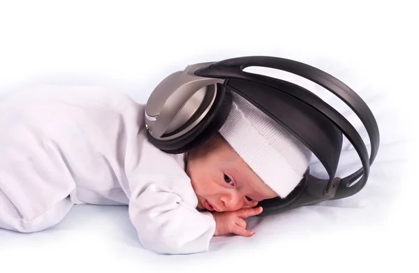 Stock image The newborn kid listening to music