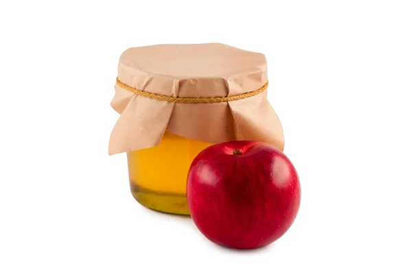 Μέλι, βάζο, ξύλινο κουτάλι, κόκκινο μήλο απομονωθεί. — Φωτογραφία Αρχείου